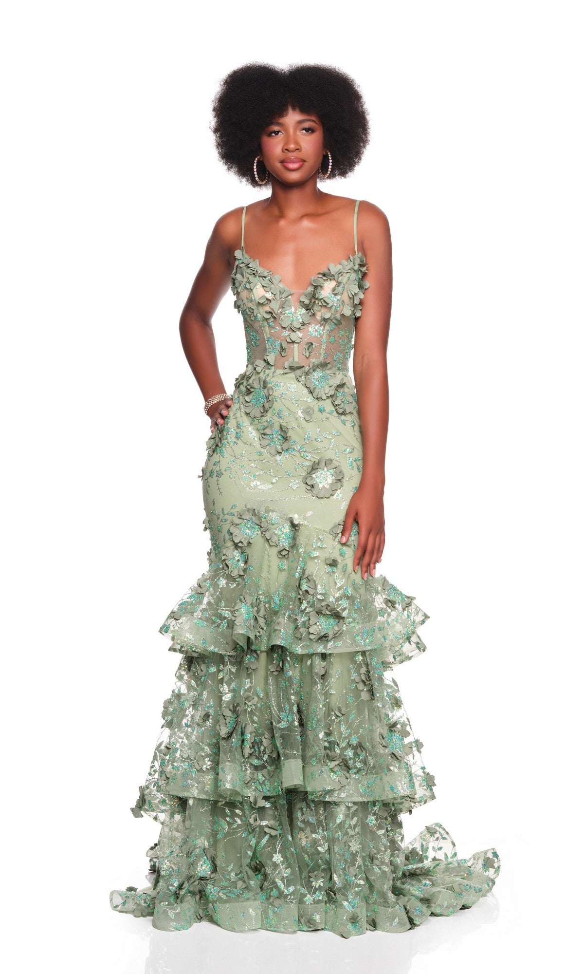 A woman poses against a white background in the Dave and Johnny 12379 long prom dress, a sleeveless, floor-length light green gown with 3D floral appliques and tiered ruffles.